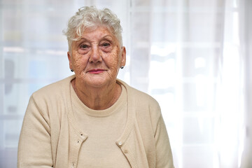 Old woman sitting on a clinic