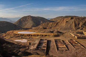 Abandoned mines of Mazarron in Southern Spain, post-apocalyptic landscape with ruins and red puddles