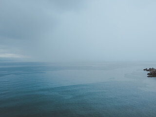 Adriatic sea shoreline during summer tempest shower rain, minimalistic landscape background