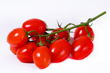 Bunch of red cherry tomatoes with a white background