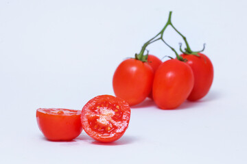 Bunch of red cherry tomatoes with a white background