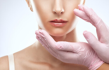 Cosmetologist does injections for lips augmentation anti wrinkle injections on the face of a...