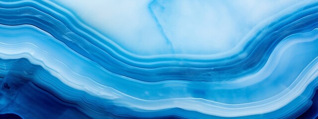 Closeup of polished abstract blue white agate crystal natural quartz healing stone texture background