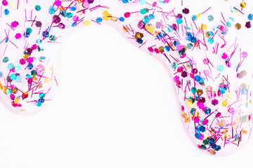 Colorful glitter sparkle confetti background liquid drops of paint color flow down on white canvas. Dark multicolored glitter paint dripping on the white wall