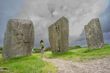 woman observing the menhirs, Megalithic Circle of Drombeg, - The Altar of the Druid-, Rosscarbery approximately from the year 150 a. c., Ireland, United Kingdom