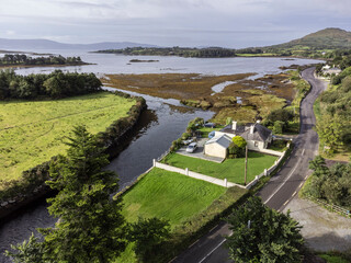 Fototapeta premium typical house and road next to Bantry Bay, Beara Peninsula, Adrigole, Beara Peninsula, County Cork, Ireland, United Kingdom