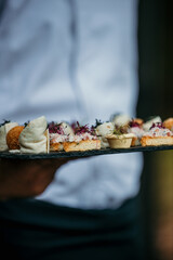 A close-up shot of an amuse-bouche, a bite-sized delight that kickstarts the culinary adventure at this garden lunch.