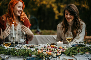 two women talking during a garden lunch.