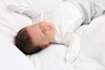 Fototapeta na wymiar Cute newborn baby sleeping on white soft bed