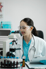 Chemist scientist holding tablet analyzing samples conducting experiment in laboratory with equipment, science concept.