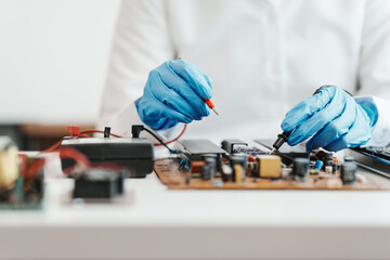 Skilled technician repairing a complex circuit board.
