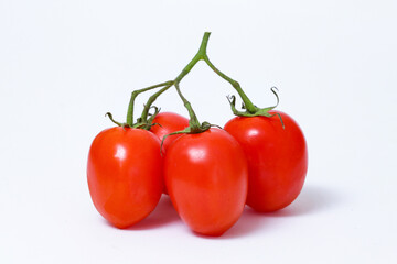 Bunch of red cherry tomatoes with a white background