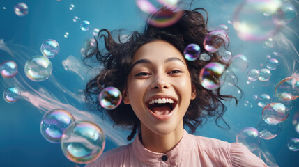 Woman enjoying being surrounded by bubbles, blue background, fun and cute, summer feeling