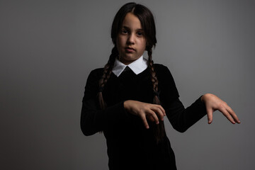 A girl with braids in a gothic style on a dark background.