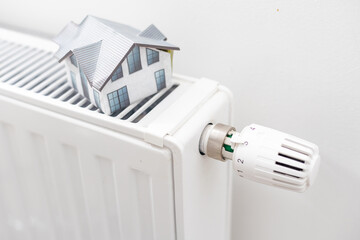 Model of house on white radiator.