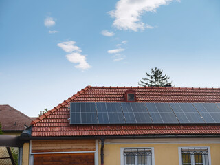 Solar photovoltaic panels on house roof. Modern country house with self-sustaining energy system. Suburb of Vienna, Austria. Idea harnessing clean and sustainable energy, saving money on electricity