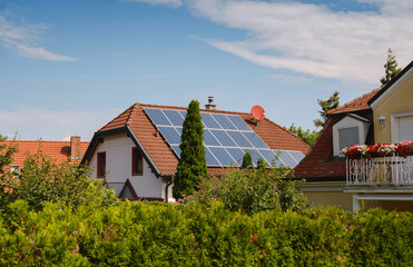 Solar photovoltaic panels on house roof. Modern country house with self-sustaining energy system. Suburb of Vienna, Austria. Idea harnessing clean and sustainable energy, saving money on electricity