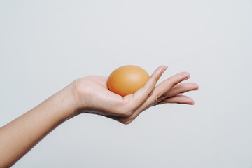 Close-up of woman hands tenderly holding free-range chicken eggs, quality assessment and natural food production, organic agriculture and sustainable living, healthy food choices and farming