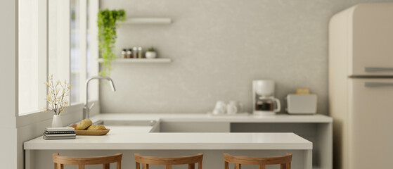 Copy space on a white kitchen countertop in a modern white kitchen interior with kitchen appliances.