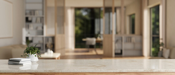 Fototapeta premium Copy space on a marble tabletop with a blurred cozy Scandinavian living room in the background.