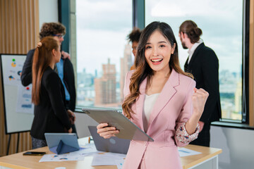Successful asian businesswoman working and looking camera in a meeting room.
