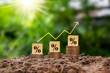 Percentage sign on wooden cube and red arrow. Idea for FED considering raising interest rates. World economy