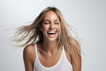 feamle model with wet hair smiling and shaking head
