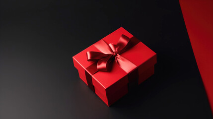 Obraz premium Gift red box with a ribbon for the holiday, black background. AI generated.