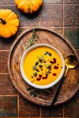 Pumpkin soup with pumpkin seeds  and pumpkin seed oil served in bowl
