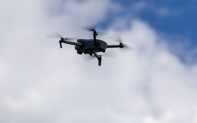 drone hovering in a bright blue sky. New technology in the aero photo shooting.