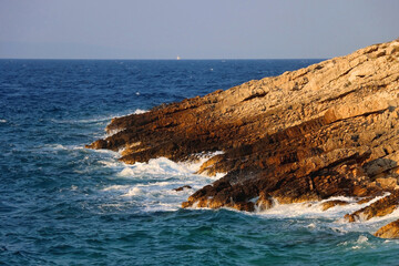 Fototapeta na wymiar Waves crashing on the rocky beach on island Korcula, Croatia.