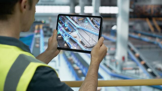 Logistics Center Worker Using Tablet Computer with Augmented Reality Software Controlling Parcel Delivery on a Conveyor Belt. International Online Shopping Business Facility with Modern Technology