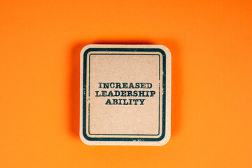 Increased leadership ability. Cardboard sticker on an orange background