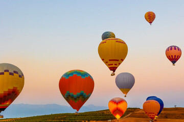 Hot air balloons at sunset , Turkey. Hot Air balloons flying tour over Mountains landscape  sunrise...