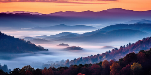 Obraz premium The mountains are shrouded in mist. A twilight shot of autumn mountains under a fading red orange purple sky.