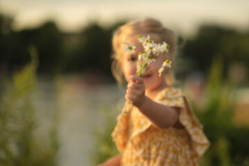 joyful little girl holding daisies amid a serene park setting suggests the therapeutic effects of flowers on our well-being. mental health benefits of floral therapy or gardening.