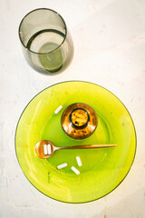 White capsules, supplements, vitamins... White tablets and pills pouring out of a medicine bottle. Macro view from above with copy space.