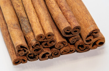 Many cinnamon sticks on a white background