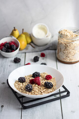 Oatmeal with berries. wooden on a white background. Breakfast