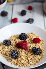 Oatmeal with berries. wooden on a white background. Breakfast