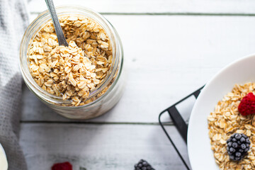 Oatmeal with berries. wooden on a white background. Breakfast
