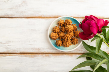Homemade soft caramel fudge candies on white wooden, top view, copy space.