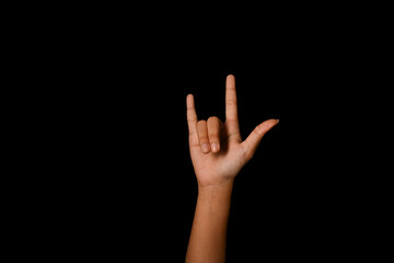Hand showing I LOVE YOU in American sign language on black background. Love, hopeful, caring and positive vibe concept