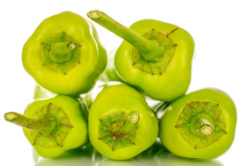 Several green chili peppers, macro, isolated on white background.