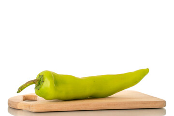 One green chili pepper with a metal knife on a wooden kitchen board, macro, isolated on white background.