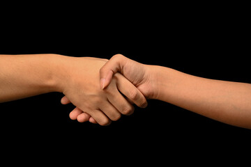 Man and woman shaking hands isolated on black background. Celebrating successful agreement, closing deal and greeting