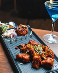 Plate of delicious barbecue chicken wings, grilled chicken with vegetables, chicken 65 Crispy chicken nuggets