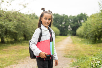 First day of school. Happy child girl elementary school student runs to class. concept back to school.