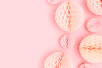 Tissue paper balls different sizes scattered on a pink background. Monochrome concept.