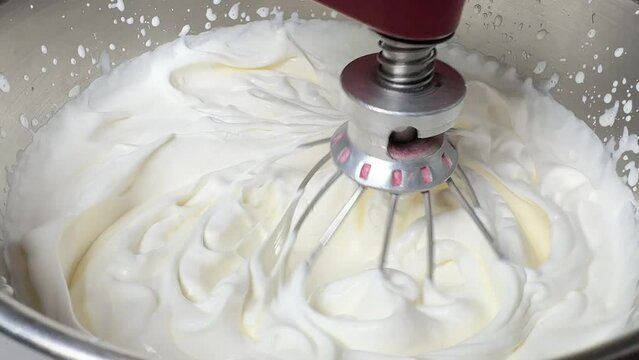 Whipped cream. Close-up of machine making whipped cream